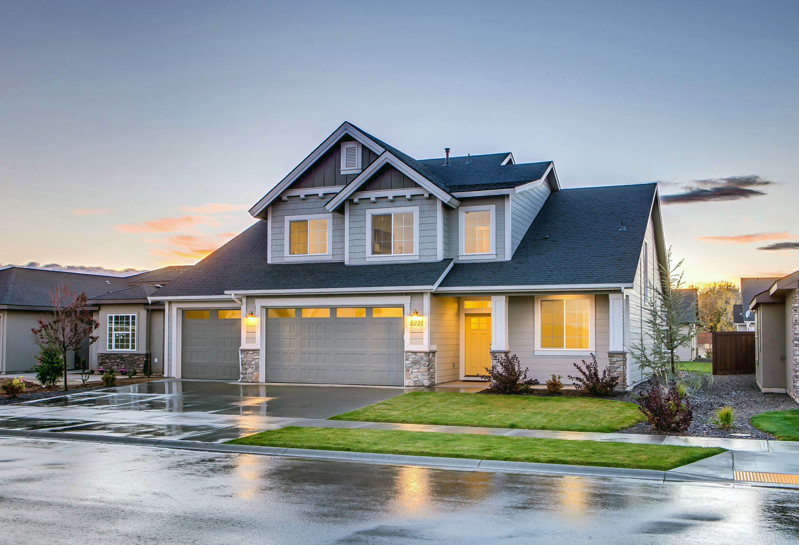 A newly installed concrete driveway and sidewalk in front of a traditional Spokane home, showcasing clean lines, smooth finish, and expert craftsmanship.