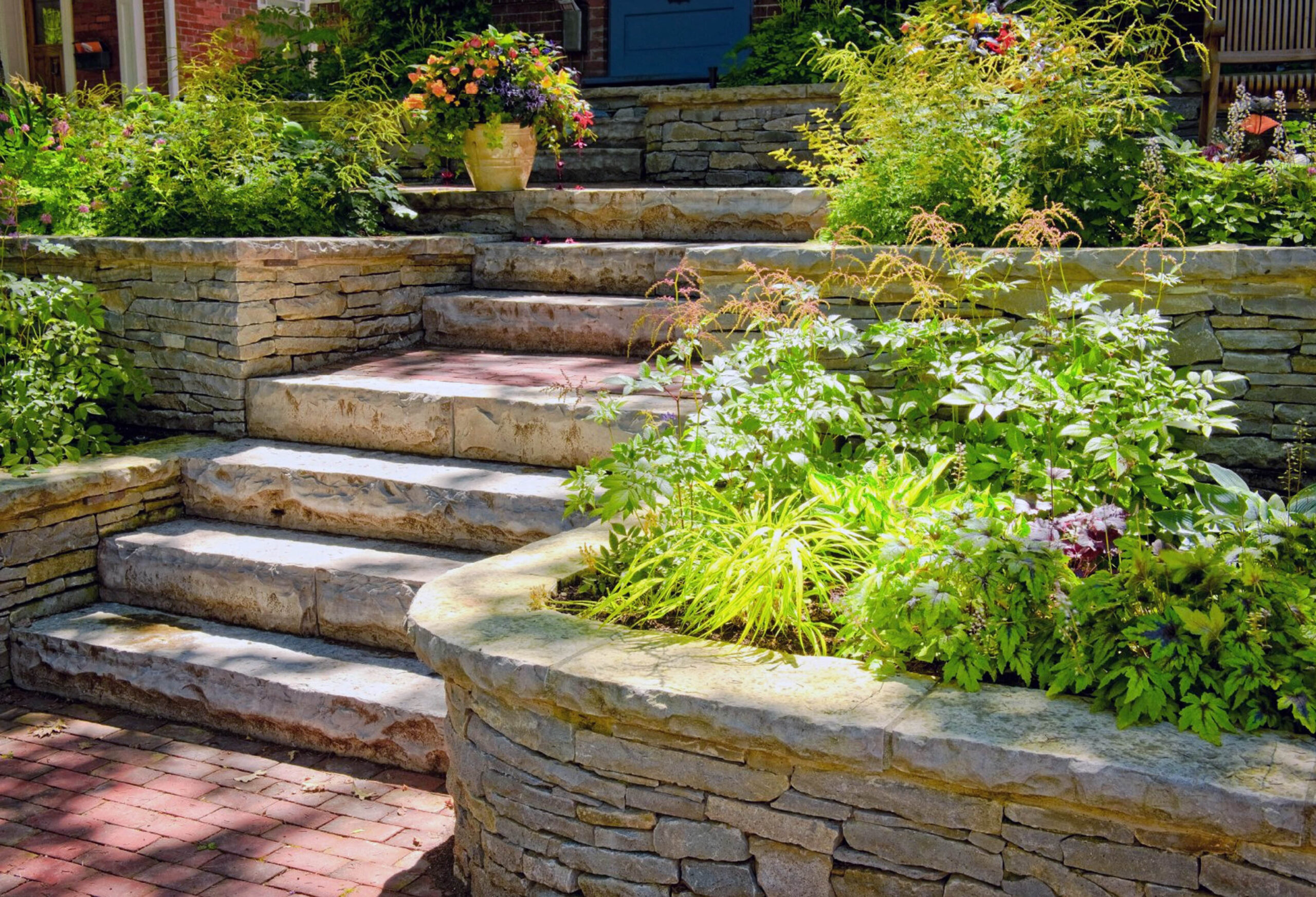 A block retaining wall in Spokane, creating tiered garden spaces with durable concrete blocks for erosion control and landscaping.